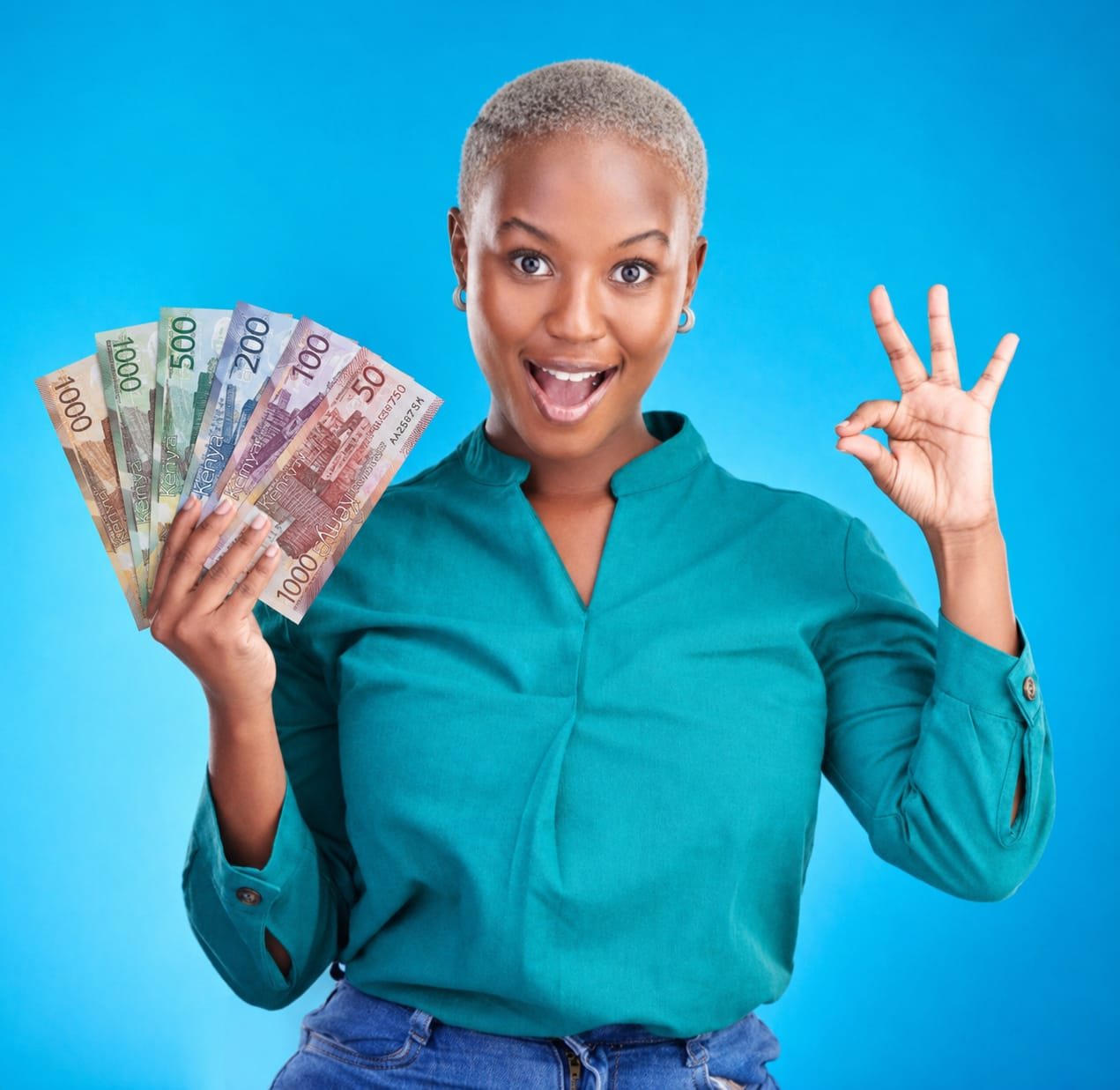 Client counting Kenyan shilling notes after a successful loan disbursement